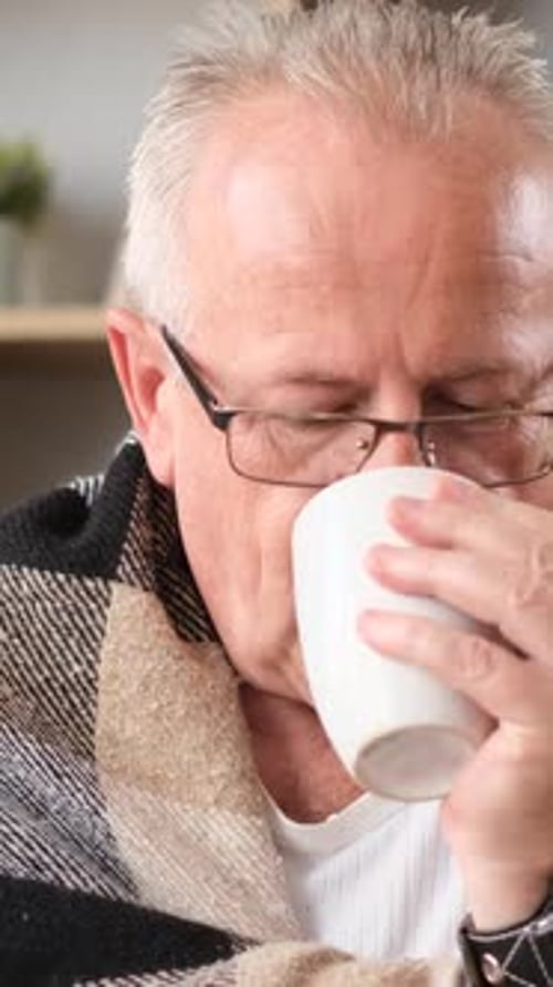 Grandfather in Glasses is Drinking Tea He Has a Cold and a Runny Nose Vertical Video