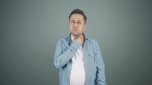 Man With Sore Throat Rubbing His Neck