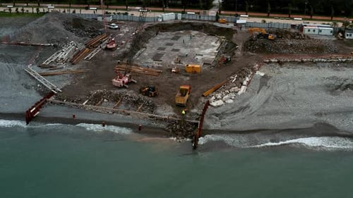 Aerial View of Construction Site with Excavators and Dump Trucks During Earthworks and Building