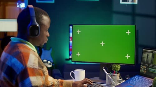 Young Adult Working with Green Screen at Night