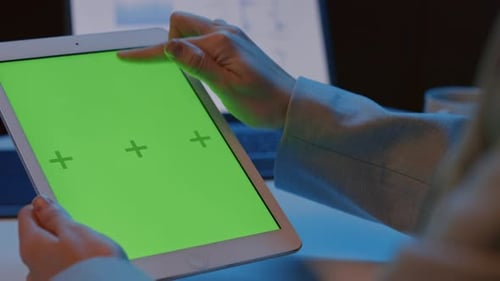 Woman Holding Tablet with Green Screen and Swiping