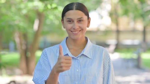 Smiling Woman Giving a Thumbs Up Gesture