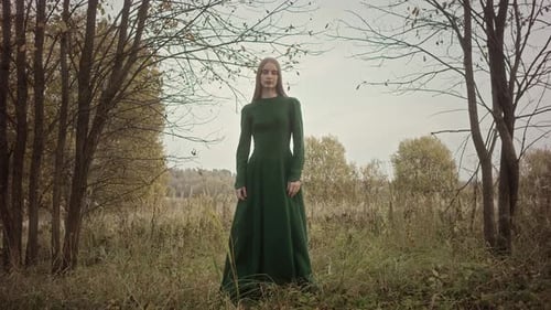 Model posing wearing green dress in autumn