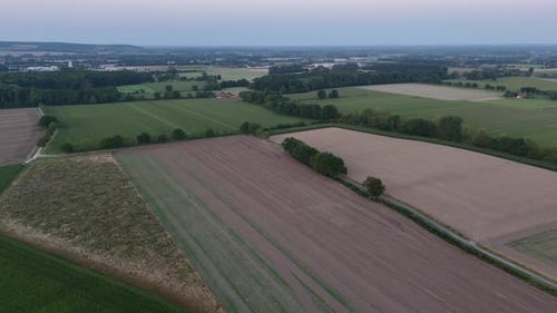 Aerial panorama view of agricultural farm fields during foggy morning. Wide shot. Cropland and corn