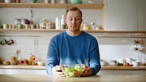 Sad Guy Looking Salad Glass Bowl Sitting Kitchen Closeup Dieting Man Sighing