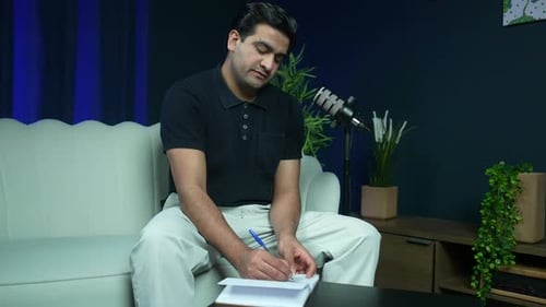 Podcast Host Reading and Signing Book During Interview