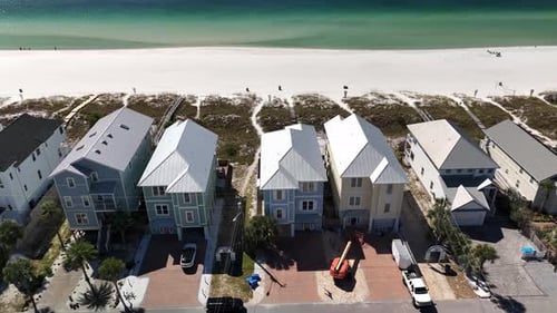 Waterfront Houses Along The White SAnd Beach In Panama City Beach, Florida, USA. - aerial shot