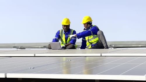 Technician installing solar cell. Installation and maintenance of solar cells on rooftop.