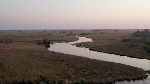 Aerial View of Natural Wetland Landscape of Meandering Cuando River at Dusk, Namibia, Africa