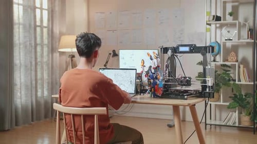 Back View Of A Boy With 3D Printing Designing A Cyborg Hand On A Laptop At Home