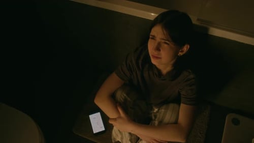 Distressed Young Woman on Bathroom Floor at Night