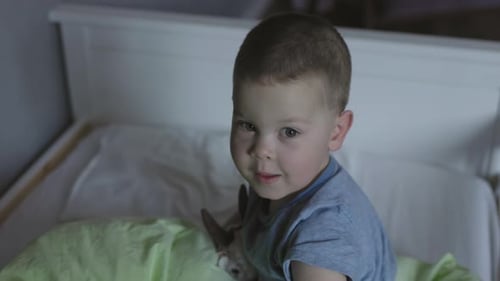 Little Kid Boy Preparing to Sleep Covering His Loving Toy with Green Blanket