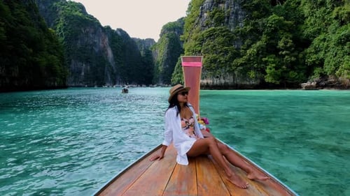 Women in Front of Longtail Boat at the Lagoon of Koh Phi Phi Thailand