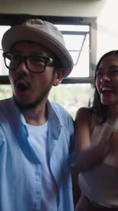 Couple Singing and Dancing Together at Home