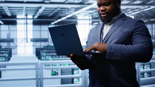 Informatiker im Server Hub überprüft den Wiederherstellungsplan auf dem Laptop