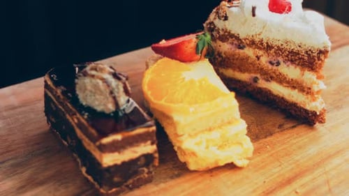 Delicious Assortment of Cake Slices on Wood Surface