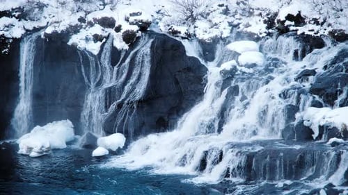 Waterfall in Iceland Snowy Mountain and Pure Blue Glacier River in Winter