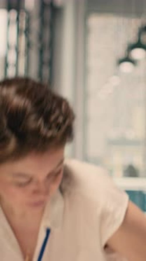 Vertical Video Portrait of Woman Reviewing Business Intelligence and Analytics Dashboard