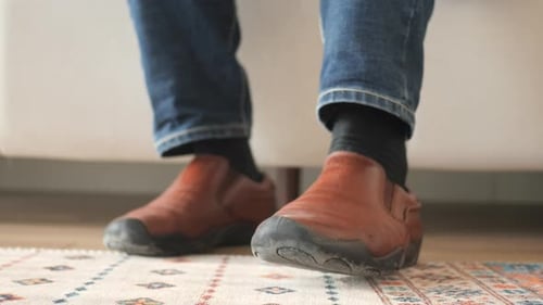 Feet Wearing Brown Dress Shoes Standing on Carpet