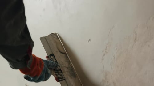 Smoothing Plaster on Wall with Float Tool During Finishing Close Up