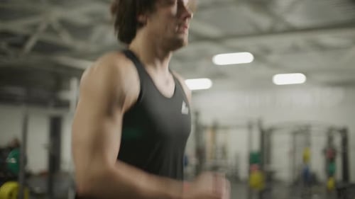 Athletic Man in Sportswear Running on Treadmill in Gym