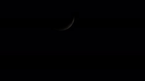 Waxing Crescent Moon covered with clouds then reveals again as it descends from the sky.