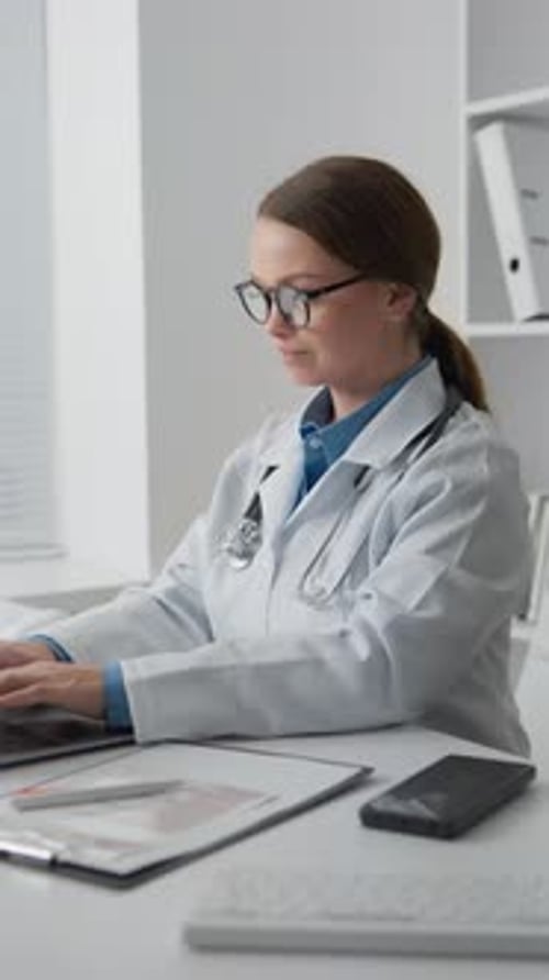 Female Doctor Working on Laptop in Modern Office