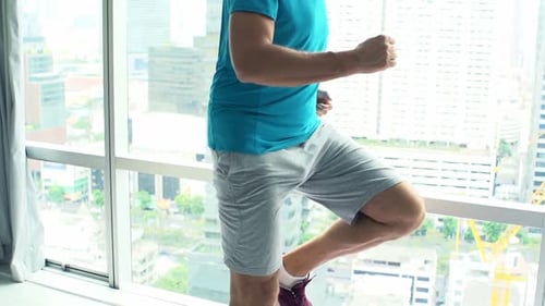Young Man Doing Warmup, Running by Window in Gym, Super