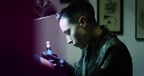 Milan/Italy-01.02.2019:Slow motion of professional female master of the art of tattooing doing a t