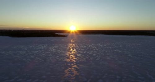Aerial sunset of winter ice landscape