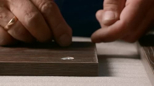 Close-up of man inserting screws into wooden board