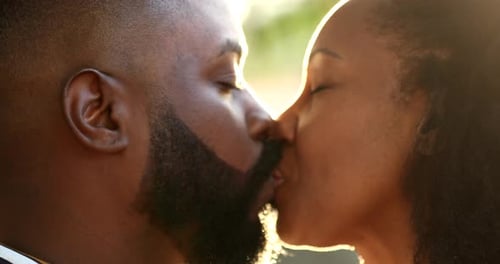 Romantic Couple Kissing in Sunlight Glow Together