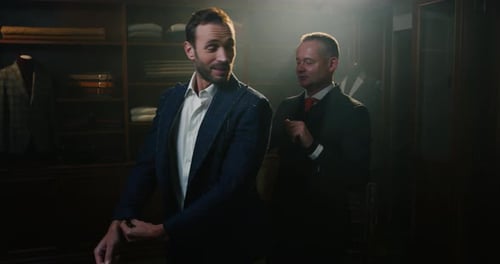 Cinematic shot of young businessman is trying his new custom made high quality tailored suit with