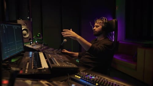 Soundman Working in Professional Record Studio Portrait of Man with Mixer Skilled Sound Director