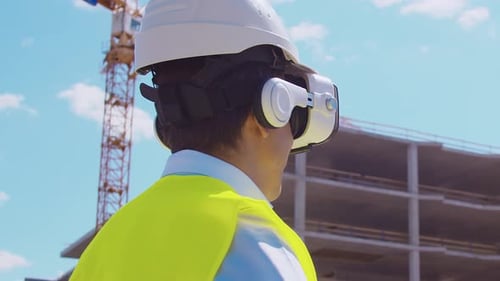 Construction Worker Using VR Headset at Building Site
