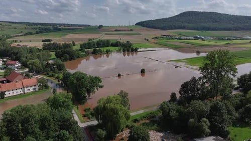 Aerial view of flooded village surrounded by fields, Germany.