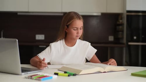 Child Studying and Writing at Home Indoors