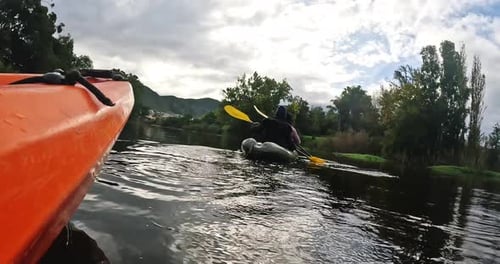 Kayaking, water sport and friends on a boat in the lake while on a vacation