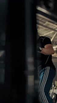 Vertical of Boxer Shadow Boxing Boxer Swings and Kicks and Kicks the ...