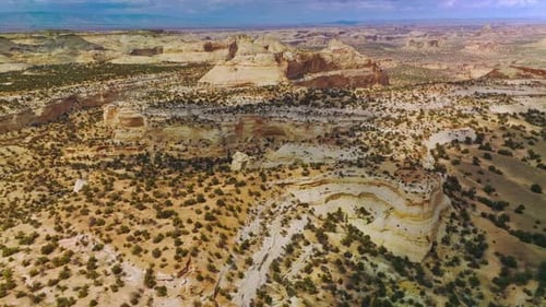 Rocky landscape of endless desert with little bushes of greenery. Amazing canyons of Utah