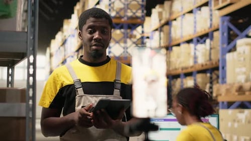 Black Ecommerce Worker Filming a Promotional Video Inside a Fulfillment Center