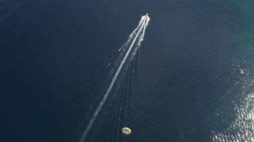 Aerial view of a person doing parasail in Sicily, Italy.
