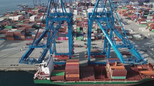 Aerial View of a Port Container Terminal with Cranes Loading a Ship