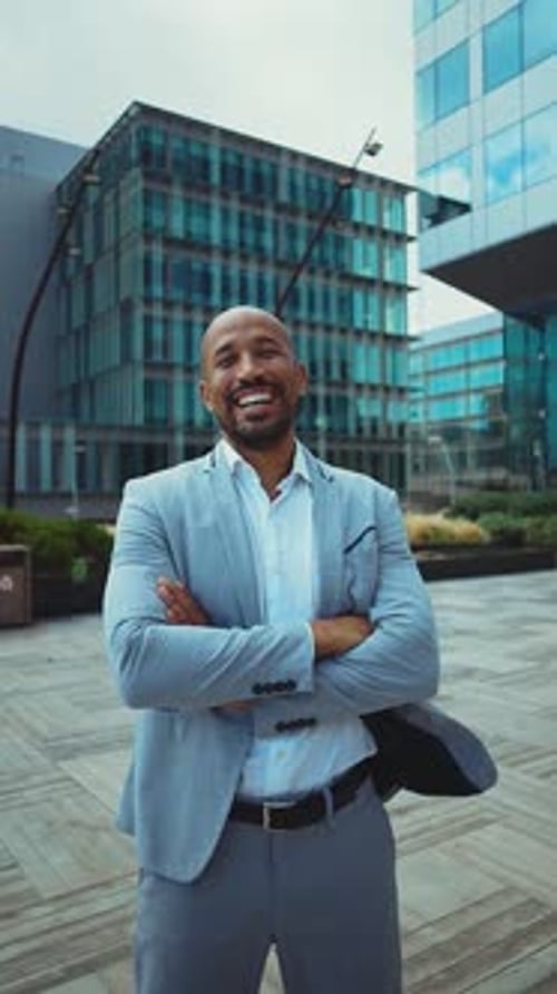 Confident Man Smiles in an Urban Business Environment