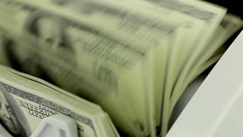 Synergy Collection: A close up shot of a bank bills being counted in money counting machine