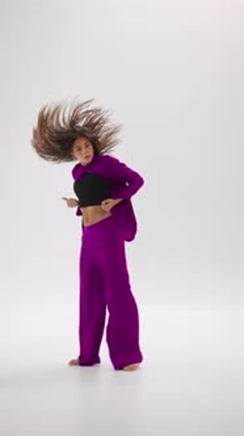 Young Female Dancer In Dynamic Outfit Performing In Minimal Studio