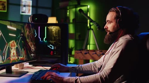 Bearded Man Playing Video Game at Computer