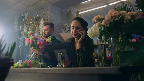Woman Talking on Cellphone in Flower Shop
