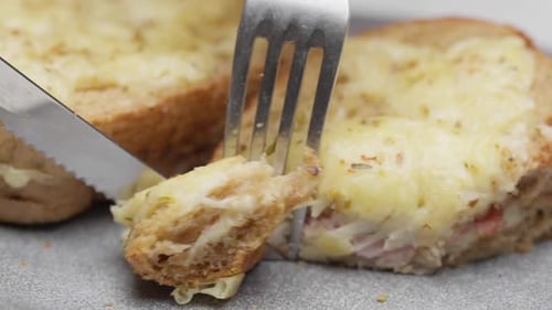 Cutting Grilled Cheese and Ham Sandwich Close Up