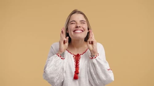 Young Woman Crossing Fingers and Wishing